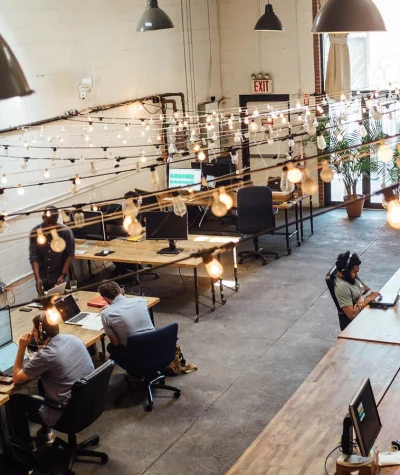 An office where not all desks are occupied, because some employees are working remotely.